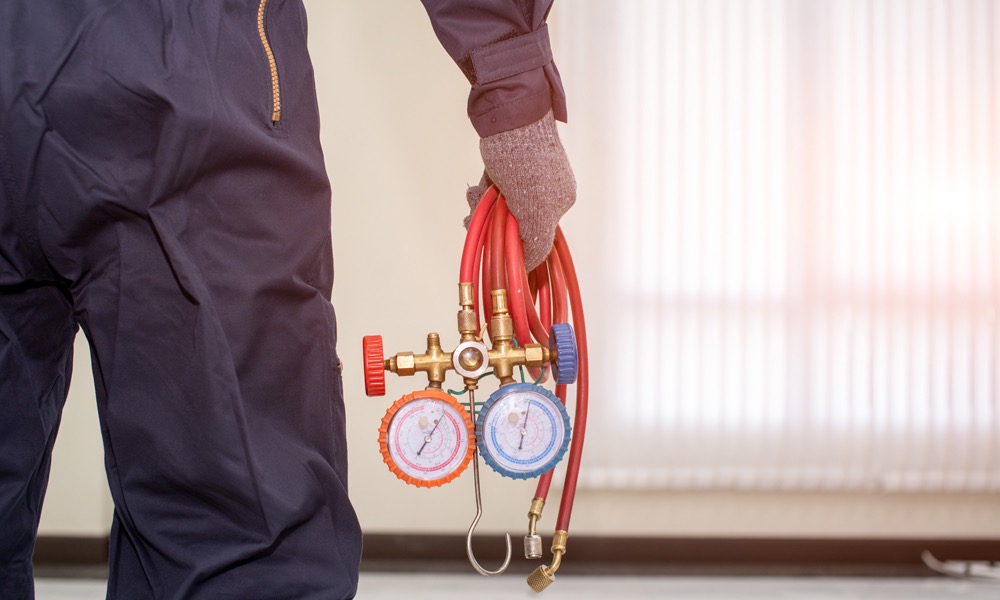 HVAC Tech holding gauges